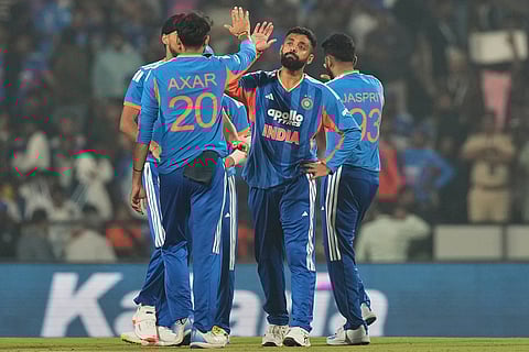 India's Varun Chakravarthy, second right, celebrates with teammates after the dismissal of New Zealand's Mark Chapman during the first T20 cricket match between India and New Zealand in Nagpur, India.