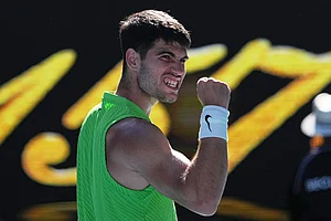 | Photo: AP/Dita Alangkara : Carlos Alcaraz of Spain celebrates after defeating Yannick Hanfmann of Germany in their second round match at the Australian Open tennis championship in Melbourne, Australia.