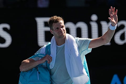 Yannick Hanfmann of Germany waves as he leaves the court following his second round loss to Carlos Alcaraz of Spain at the Australian Open tennis championship in Melbourne, Australia.