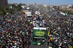 | Photo: AP/Misper Apawu : The Senegalese soccer team rides through thousands of cheering fans celebrating their victory in the Africa Cup of Nations soccer tournament, in Dakar, Senegal.