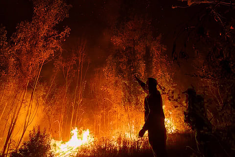 Residents watch wildfires near Concepcion, Chile.