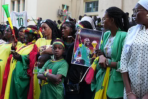 Fans celebrate the Senegalese soccer team's victory in the Africa Cup of Nations soccer tournament, in Dakar, Senegal.