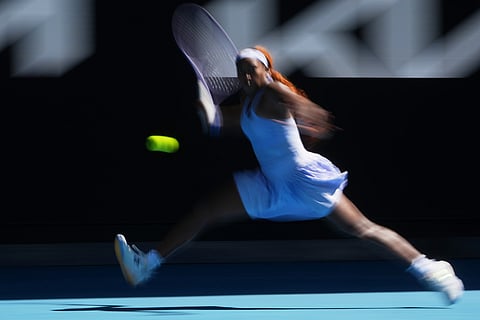 In this image taken with a slow shutter speed, Coco Gauff of the U.S. plays a forehand return to Olga Danilovic of Serbia during their second round match at the Australian Open tennis championship in Melbourne, Australia.\