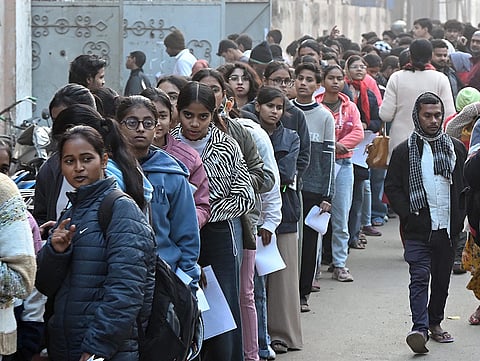 Aspirants wait in a queue outside an examination centre before appearing for the ‘JEE Mains 2026’ exam, in Patna, Bihar.