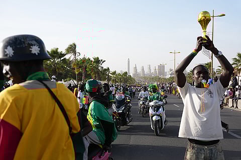 Fans celebrate the Senegalese soccer team's victory in the Africa Cup of Nations soccer tournament, in Dakar, Senegal.