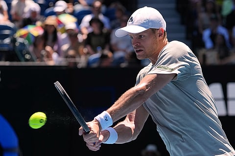 Yannick Hanfmann of Germany plays a backhand return to Carlos Alcaraz of Spain during their second round match at the Australian Open tennis championship in Melbourne, Australia.