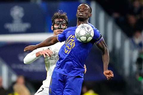 Monaco's Folarin Balogun fights for the ball against Real Madrid's Raul Asencio during the Champions League opening phase soccer match between Real Madrid and Monaco in Madrid.