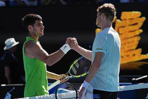 Carlos Alcaraz, left, of Spain is congratulated by Yannick Hanfmann of Germany following their second round match at the Australian Open tennis championship in Melbourne, Australia.