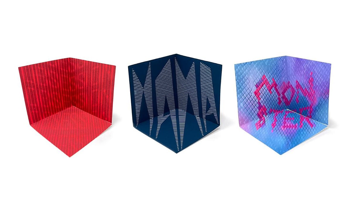 hree folded cube shapes with red lines, blue striped pattern, and purple-blue textured abstract art