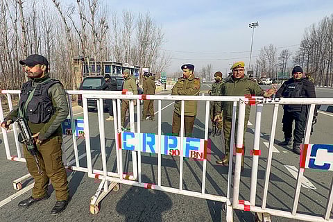Police personnel during frisking and security checks on the national highway ahead of Republic Day celebrations, in Bijbehara, Jammu and Kashmir.