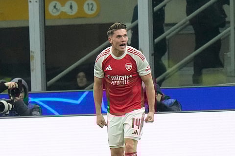 Arsenal's Viktor Gyoekeres celebrates after scoring his side's third goal during the Champions League opening phase soccer match between Inter Milan and Arsenal in Milan, Italy.