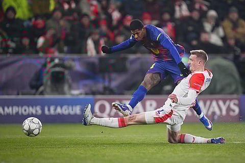 Barcelona's Marcus Rashford, top, attempts a shot at goal in front of Slavia's Stepan Chaloupek during the Champions League opening phase soccer match between Slavia Prague and Barcelona in Prague, Czech Republic.