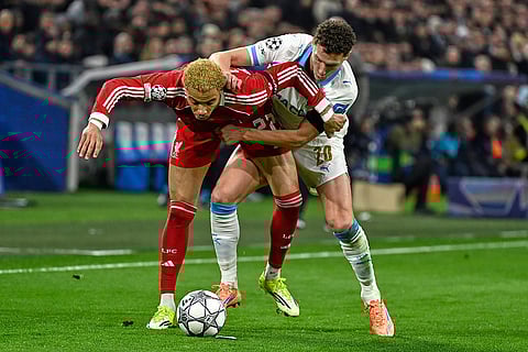 Marseille's Hamed Traore, right, challenges for the ball with Liverpool's Hugo Ekitike during the Champions League opening phase soccer match between Marseille and Liverpool in Marseille, France.