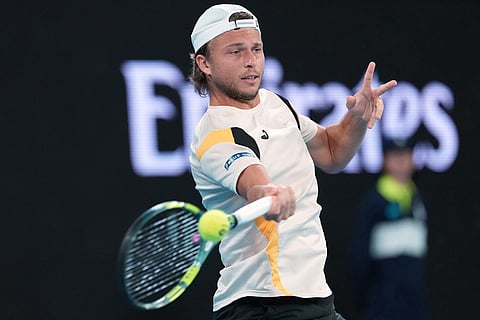 Alexandre Muller of France plays a forehand return to Alexander Zverev of Germany during their second round match at the Australian Open tennis championship in Melbourne, Australia.