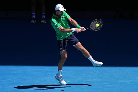 Novak Djokovic of Serbia plays a backhand return to Francesco Maestrelli of Italy during their second round match at the Australian Open tennis championship in Melbourne, Australia.