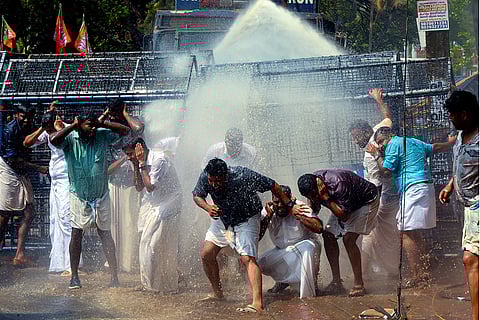 Police use water cannons to disperse Youth Congress activists during their protest near the Kerala Legislative Assembly demanding the resignation of Devaswom Minister V.N. Vasavan over the Sabarimala gold smuggling controversy, in Thiruvananthapuram.