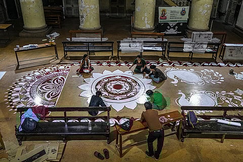 Students of 'The Sanskrit College and University' prepare rangoli in the university premises on the eve of 'Saraswati Puja', in Kolkata.
