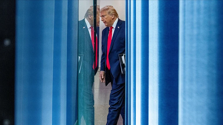 President Donald Trump arrives to speak with reporters in the James Brady Press Briefing Room at the White House, Tuesday, Jan. 20, 2026, in Washington. - Alex Brandon/ AP