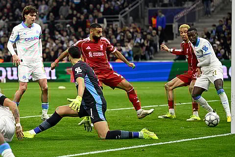 Marseille's goalkeeper Geronimo Rulli, left, scores an own goal during the Champions League opening phase soccer match between Marseille and Liverpool in Marseille, France.