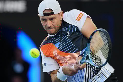 James Duckworth of Australia plays a backhand return to Jannik Sinner of Italy during their second round match at the Australian Open tennis championship in Melbourne, Australia.