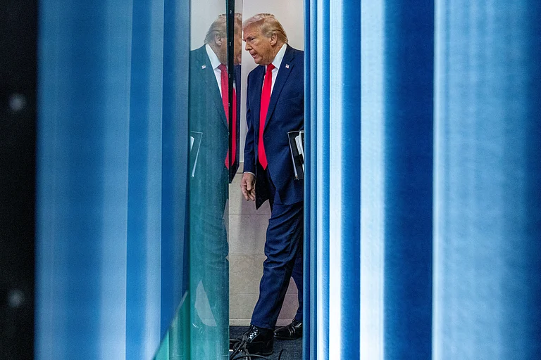 President Donald Trump arrives to speak with reporters in the James Brady Press Briefing Room at the White House, Tuesday, Jan. 20, 2026, in Washington. - Alex Brandon/ AP