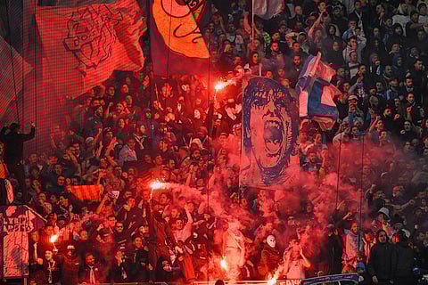 Fans burn flares and waves flags during the Champions League opening phase soccer match between Marseille and Liverpool in Marseille, France.