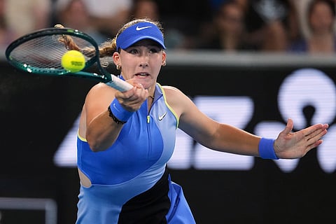 Mirra Andreeva of Russia plays a forehand return to Maria Sakkari of Greece during their second round match at the Australian Open tennis championship in Melbourne, Australia.