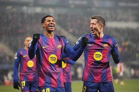 Barcelona's Robert Lewandowski, right, celebrates with his teammate Marcus Rashford after scoring his side's fourth goal during the Champions League opening phase soccer match between Slavia Prague and Barcelona in Prague, Czech Republic.