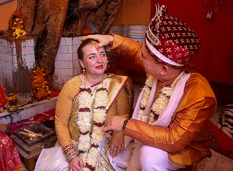 A Russian couple, Konstantin Mering and Marina, perform rituals during a traditional Vedic Hindu wedding ceremony, in Varanasi.