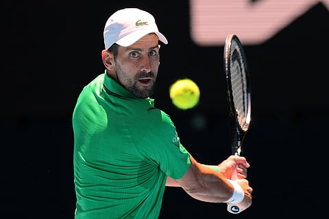 Novak Djokovic of Serbia plays a backhand return to Francesco Maestrelli of Italy during their second round match at the Australian Open tennis championship in Melbourne, Australia.
