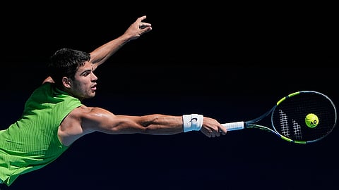 Carlos Alcaraz of Spain plays a backhand return to Corentin Moutet of France during their third round match at the Australian Open tennis championship in Melbourne, Australia.