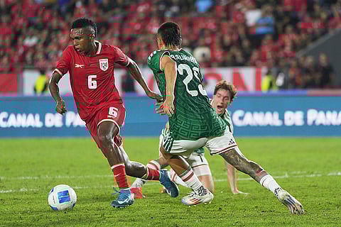 Panama's Hector Hurtado dribbles away from Mexico's Roberto Alvarado vie for the ball during an international friendly soccer match in Panama City.