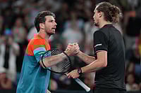 | Photo: AP/Aaron Favila : Alexander Zverev, right, of Germany is congratulated by Cameron Norrie, left, of Britain following their third round match at the Australian Open tennis championship in Melbourne, Australia.