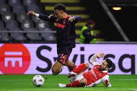 Nottingham Forest's Dan Ndoye, left, falls to the ground in the box next to Braga's Joao Moutinho during the Europa League opening phase soccer match between SC Braga and Nottingham Forest in Braga, Portugal.