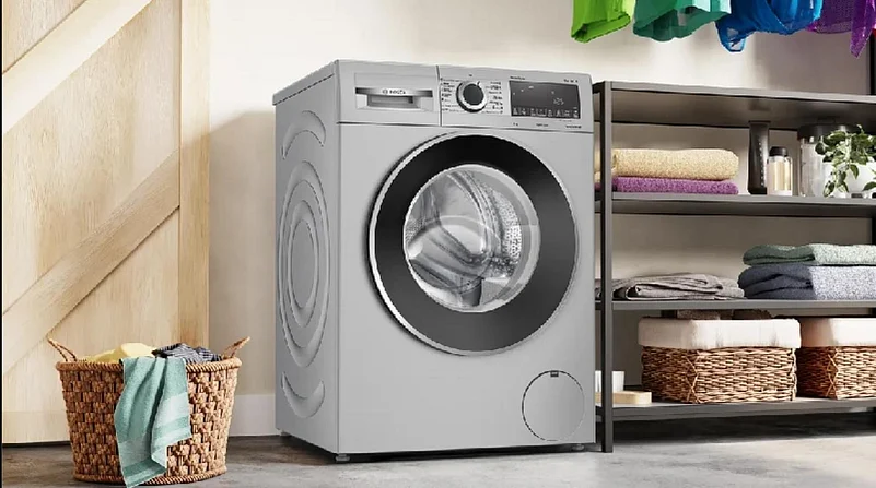 A silver Bosch front-load washing machine in a laundry room