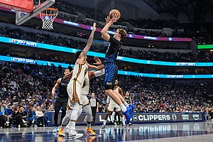 | Photo: AP/Tony Gutierrez : Dallas Mavericks forward Cooper Flagg shoots over Golden State Warriors' Gui Santos, left, in the second half of an NBA basketball game in Dallas.