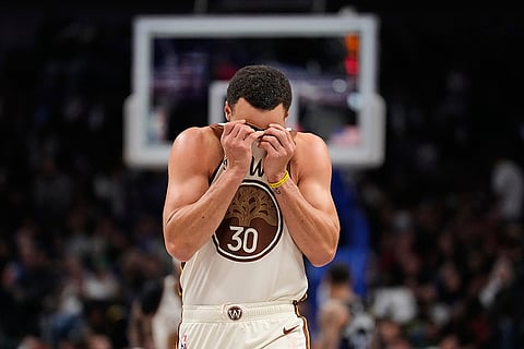 Golden State Warriors guard Stephen Curry wipes his face with his jersey in the second half of an NBA basketball game againast the Dallas Mavericks in Dallas.