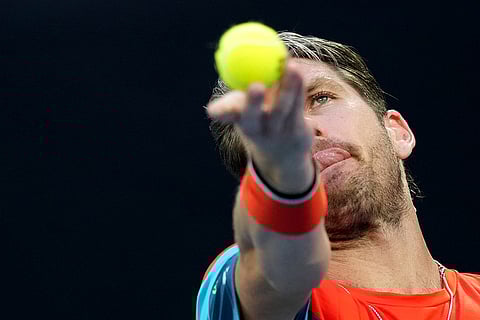 Cameron Norrie of Britain serves to Alexander Zverev of Germany during their third round match at the Australian Open tennis tournament in Melbourne, Australia.