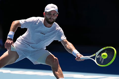 Corentin Moutet of France plays a forehand return to Carlos Alcaraz of Spain during their third round match at the Australian Open tennis championship in Melbourne, Australia.