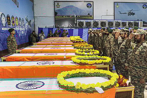 Army personnel pay homage to martyrs during a wreath-laying ceremony at the Air Force Station, following a tragic accident in which 10 soldiers were killed when their truck skidded off the road and plunged into a deep gorge in Doda district on Thursday, in Jammu.