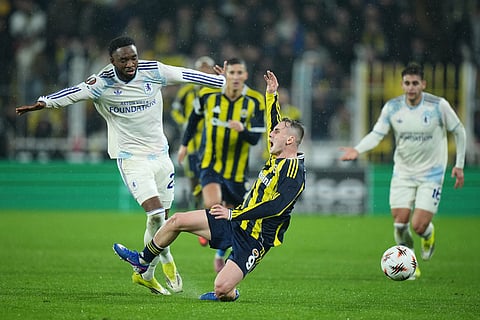 Fenerbahce's Kerem Akturkoglu, right, is tackled by Aston Villa's Lamare Bogarde during a Europa League opening phase soccer match between Fenerbahce and Aston Villa, in Istanbul, Turkey.