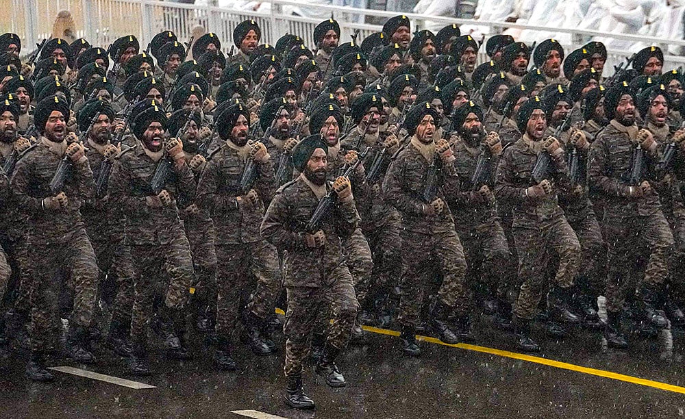 Indian Army contingent marches during rain-affected full-dress rehearsal for the Republic Day Parade, in New Delhi. - | Photo: PTI/Kamal Kishore