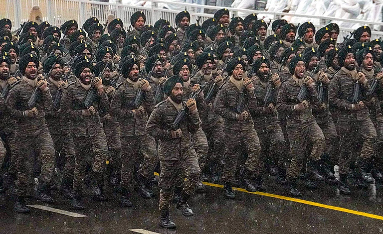 Indian Army contingent marches during rain-affected full-dress rehearsal for the Republic Day Parade, in New Delhi. - | Photo: PTI/Kamal Kishore