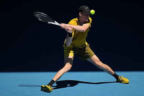 Jannik Sinner of Italy plays a backhand return to Eliot Spizzirri of the U.S. during their third round match at the Australian Open tennis championship in Melbourne, Australia.