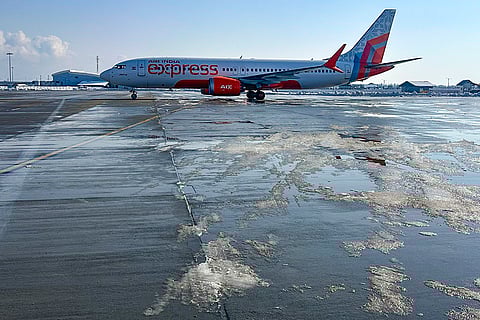 An Air India Express aircraft, seen at the Srinagar airport, as flight operations, which were suspended due to heavy snowfall before, resumed after snow was removed from the runway. 