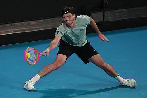 Taylor Fritz of the U.S. plays a forehand return to Stan Wawrinka of Switzerland during their third round match at the Australian Open tennis championship in Melbourne, Australia.