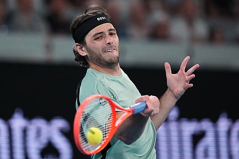 Taylor Fritz of the U.S. plays a forehand return to Stan Wawrinka of Switzerland during their third round match at the Australian Open tennis championship in Melbourne, Australia.