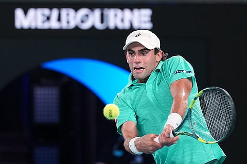 Eliot Spizzirri of the U.S. plays a backhand return to Jannik Sinner of Italy during their third round match at the Australian Open tennis championship in Melbourne, Australia.