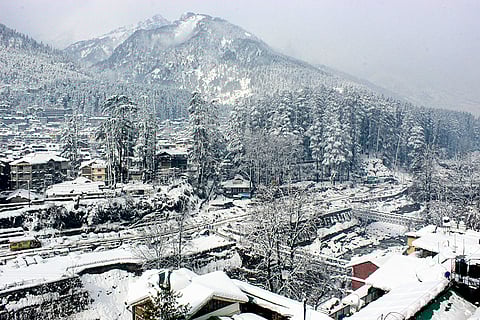 Snow-capped hills and houses after fresh snowfall, at Manali in Kullu district, Himachal Pradesh.