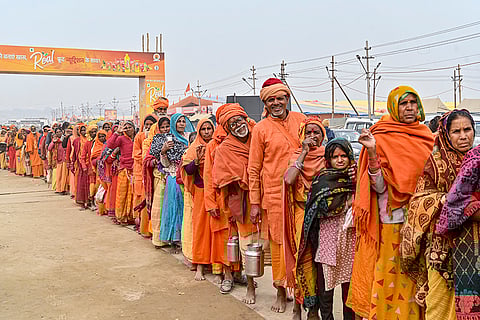 Devotees stand in long queues to receive free meal, also known as 'Bhandara', during the Magh Mela at the Sangam, in Prayagraj.